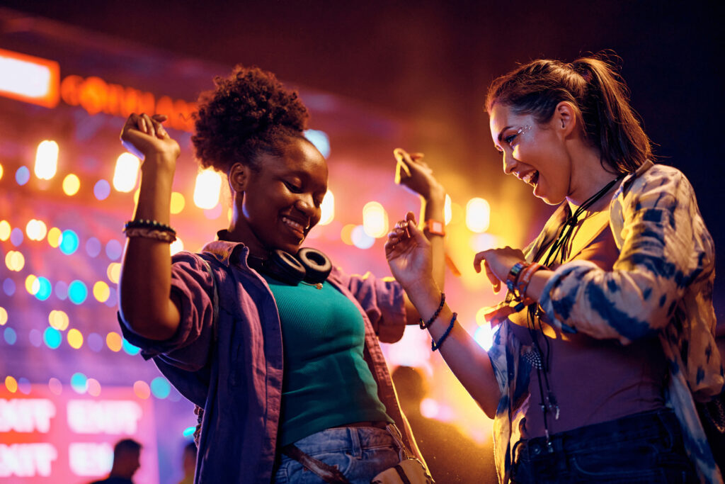 Women dancing, stage lights in background